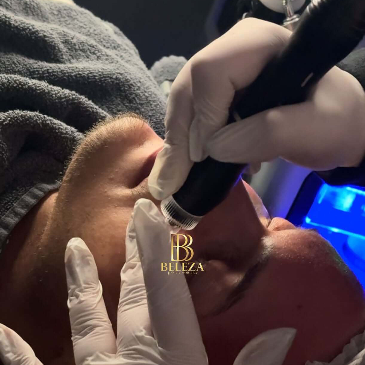 Client receiving a facial treatment, showcasing skincare procedure with professional hands and equipment.